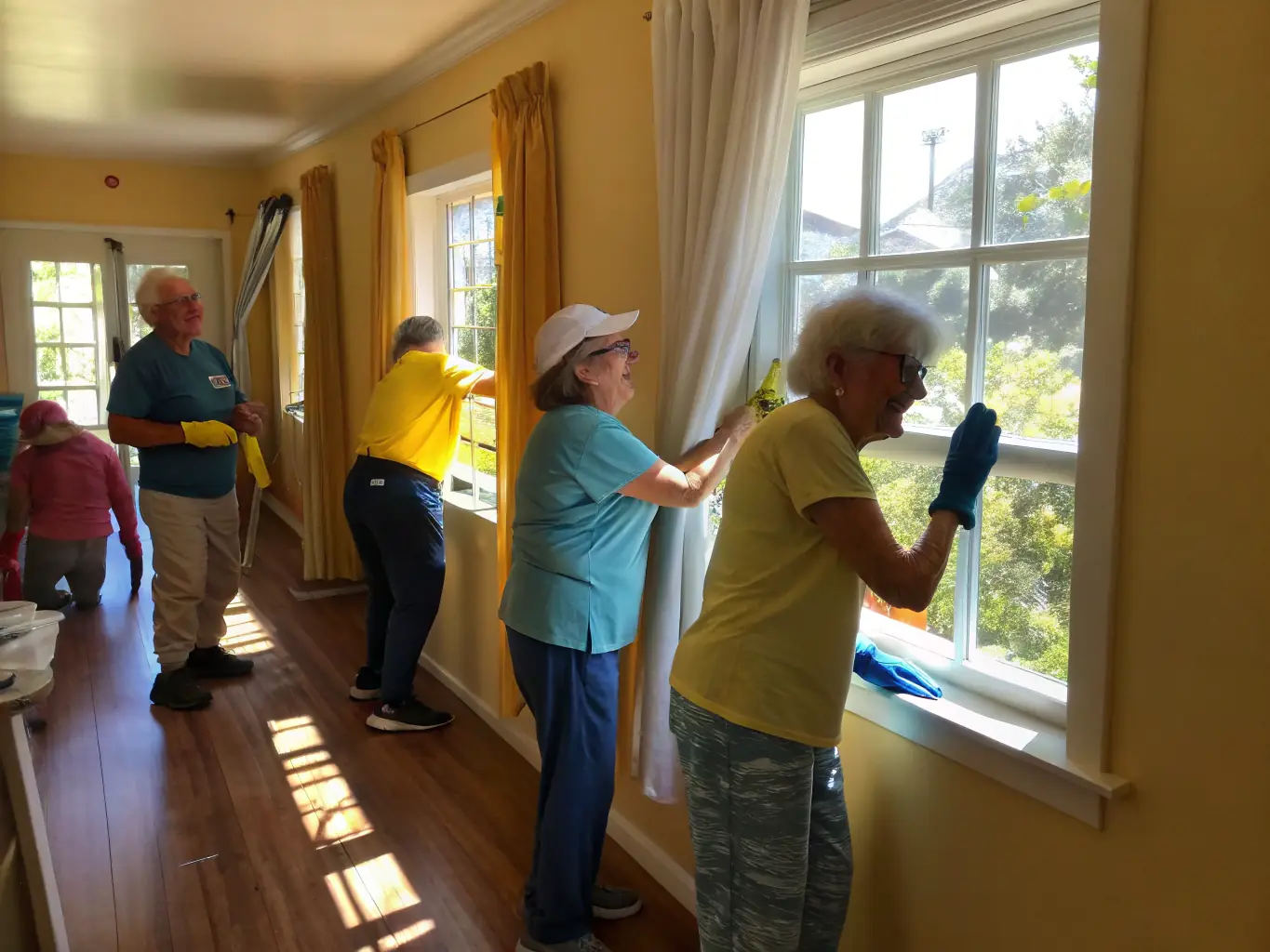 A photograph depicting volunteers assisting elderly individuals with creative arts and crafts, highlighting the intergenerational programs.